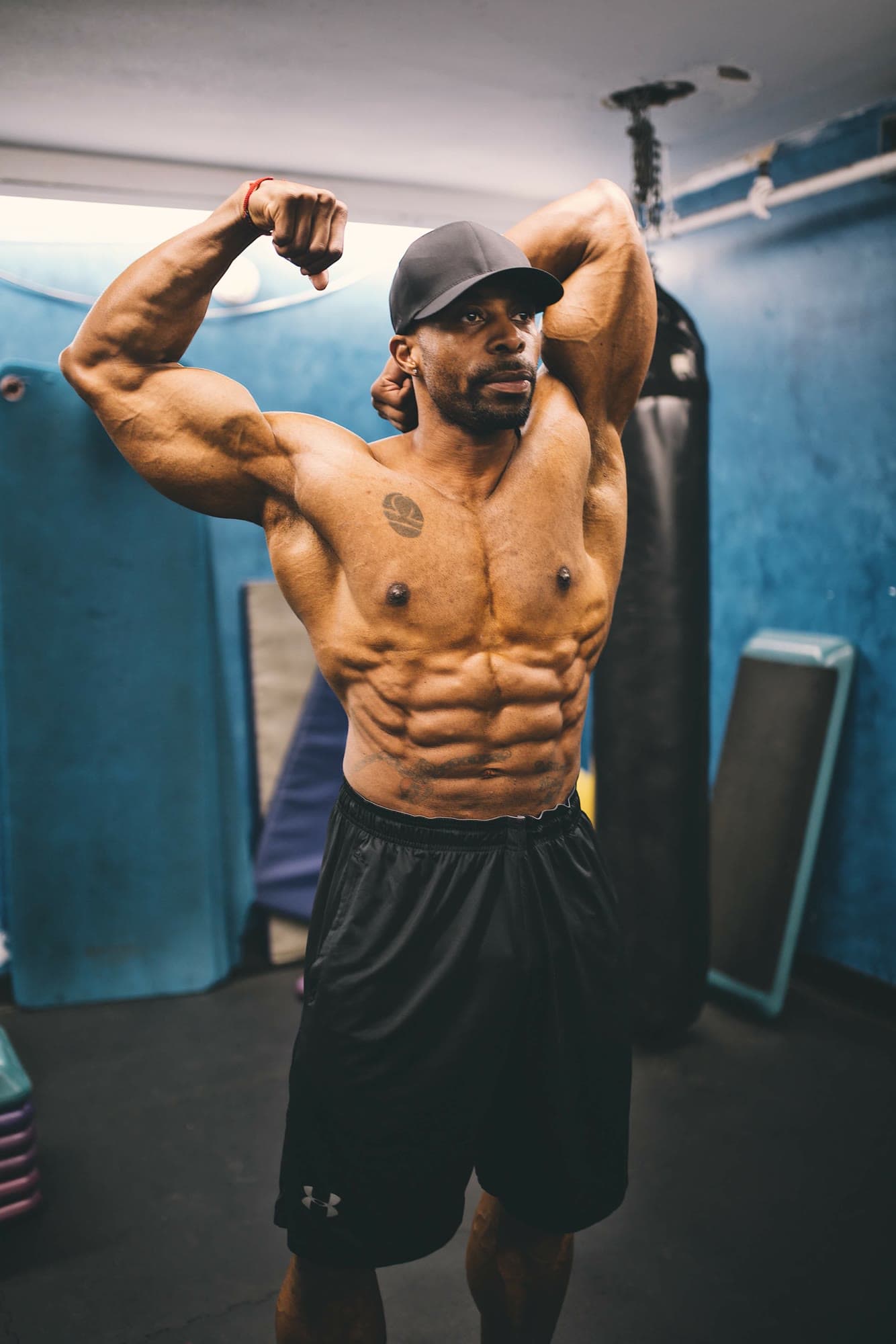 IFBB Pro Daine Chang flexing in the gym