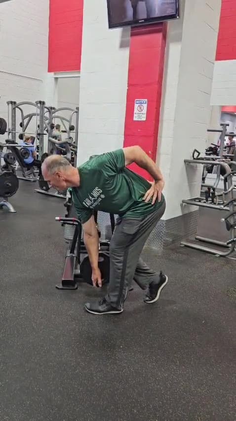 A client hinging at the hips during a warm-up