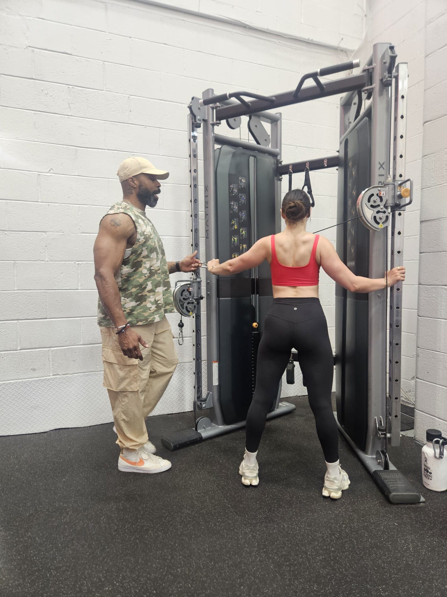 Daine Chang coaching a client through a cable exercise