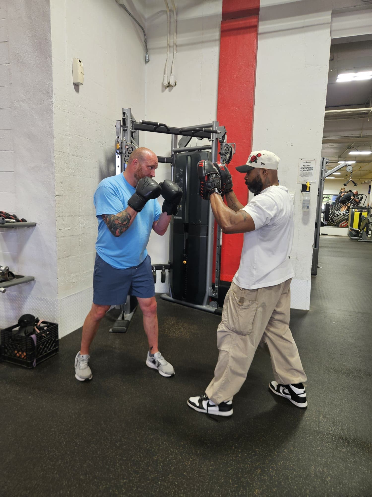 Daine Chang on the pads with a client throwing a punch
