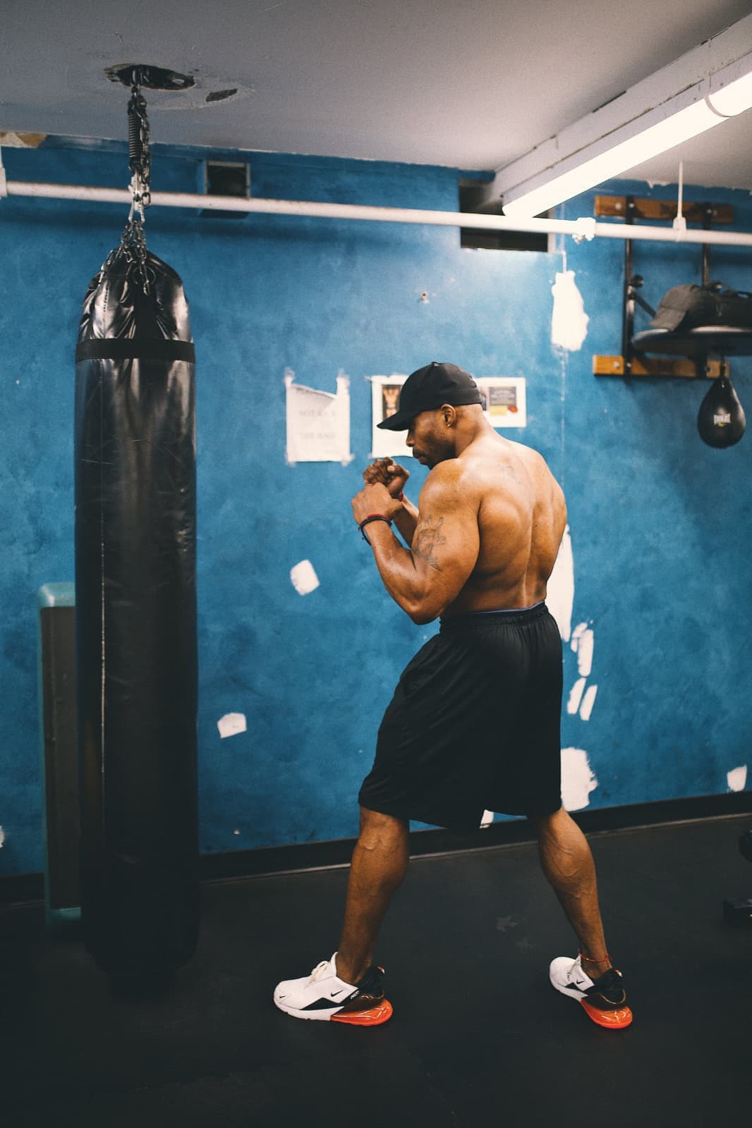 Daine Chang shadowboxing in a blue-walled gym